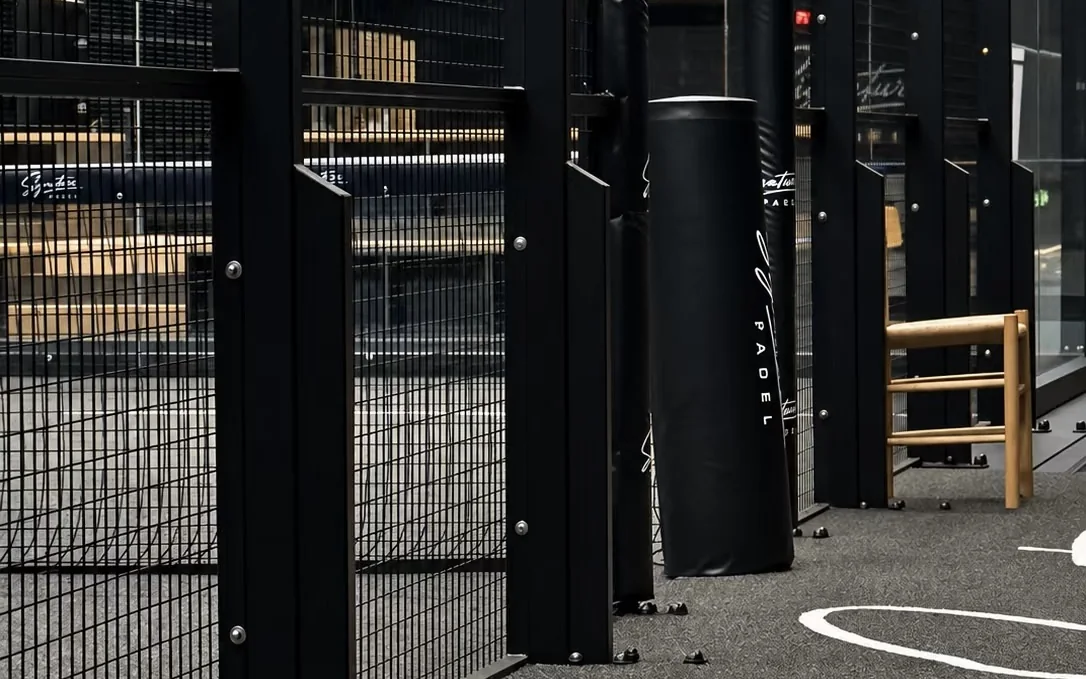 Padel court steel posts, welded mesh panels and floor anchors on an indoor court by Dream Courts